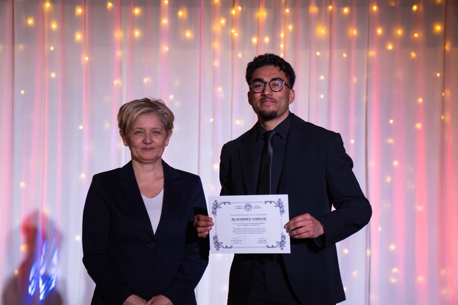 Aarham receiving a certificate from the Faculty of Dentistry, University of Debrecen